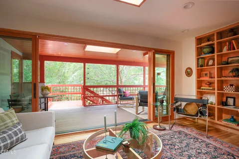 a living room with furniture and a floor to ceiling window