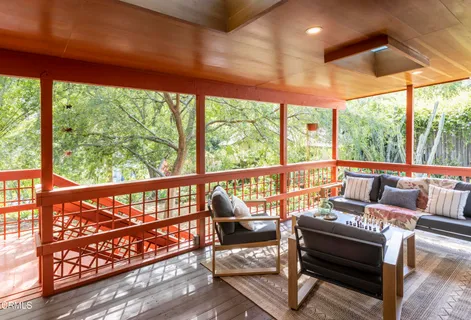 a room with furniture and a floor to ceiling window