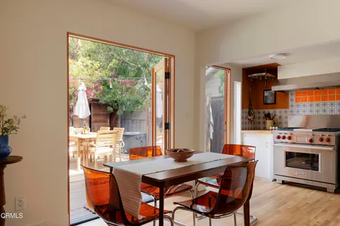 a kitchen with granite countertop a sink stove and refrigerator