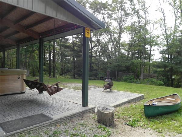 17 Spectacle Pond Road Wareham, MA 02538 - Photo 6 of 19 a view of a patio with a table chairs and a slide