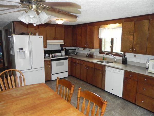 17 Spectacle Pond Road Wareham, MA 02538 - Photo 7 of 19 a kitchen with stainless steel appliances granite countertop a sink a stove a refrigerator cabinets and living room view