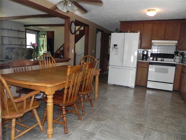 17 Spectacle Pond Road Wareham, MA 02538 - Photo 8 of 19 a kitchen with a table chairs refrigerator and cabinets