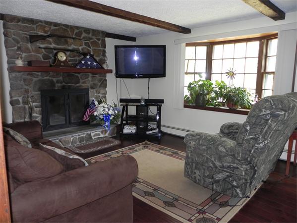 17 Spectacle Pond Road Wareham, MA 02538 - Photo 9 of 19 a living room with furniture and a fireplace