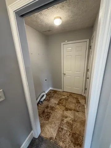 a view of a hallway with a white walls