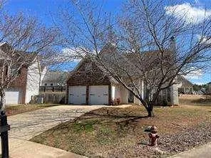 a house that has a tree in front of it