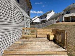 836 Freedom Walk Locust Grove, GA 30248 - Photo 4 of 21 a view of a brick house with many windows