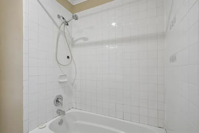 a bathroom with a bath tub with a shower