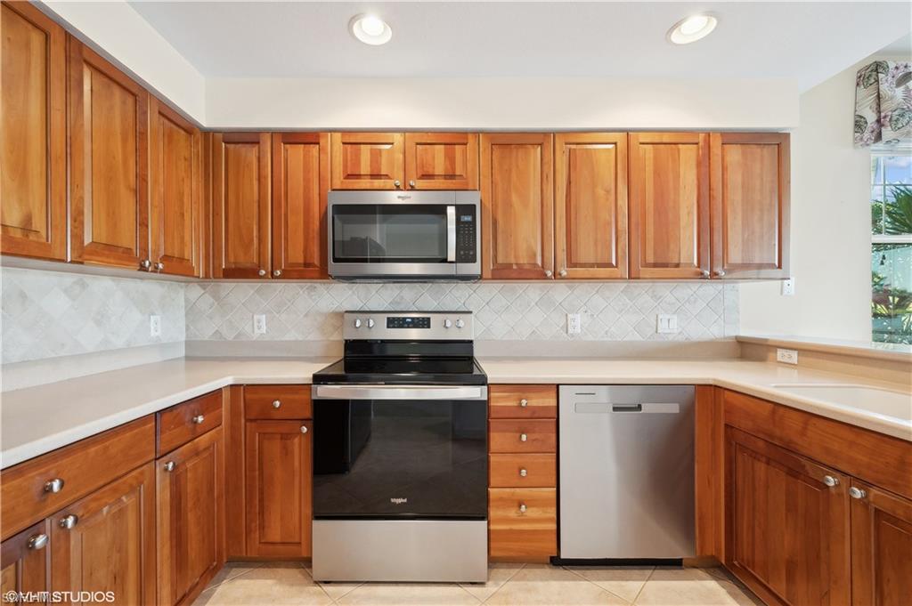 22931 Rosedale Drive, Unit 101 Estero, FL 34135 - Photo 15 of 35 a kitchen with a sink stove and microwave