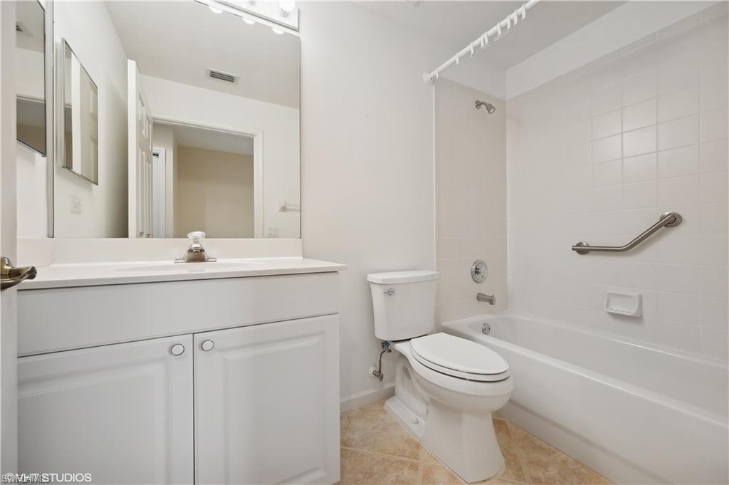 22931 Rosedale Drive, Unit 101 Estero, FL 34135 - Photo 22 of 35 a bathroom with a sink toilet and shower