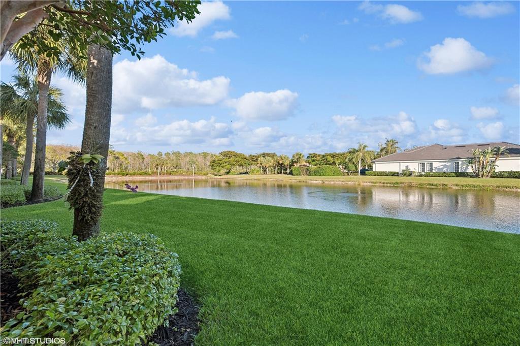 22931 Rosedale Drive, Unit 101 Estero, FL 34135 - Photo 26 of 35 a view of a lake with houses in the back