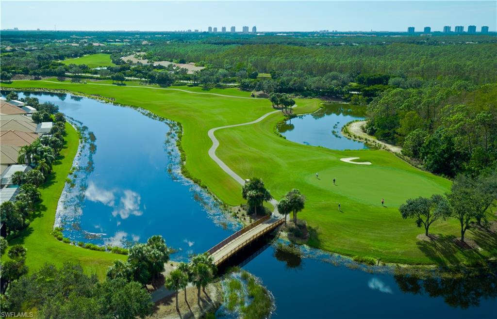 22931 Rosedale Drive, Unit 101 Estero, FL 34135 - Photo 29 of 35 an aerial view of a golf course with a garden