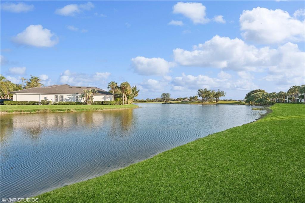 22931 Rosedale Drive, Unit 101 Estero, FL 34135 - Photo 3 of 35 a view of a lake with houses in the back