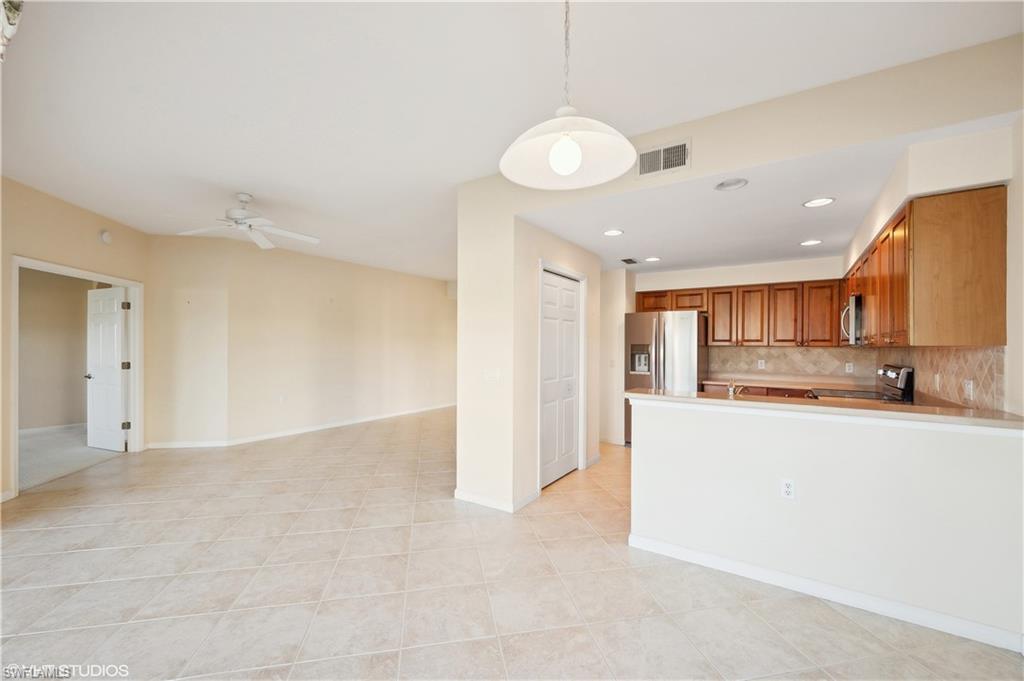 22931 Rosedale Drive, Unit 101 Estero, FL 34135 - Photo 4 of 35 a view of a kitchen with a sink and cabinets
