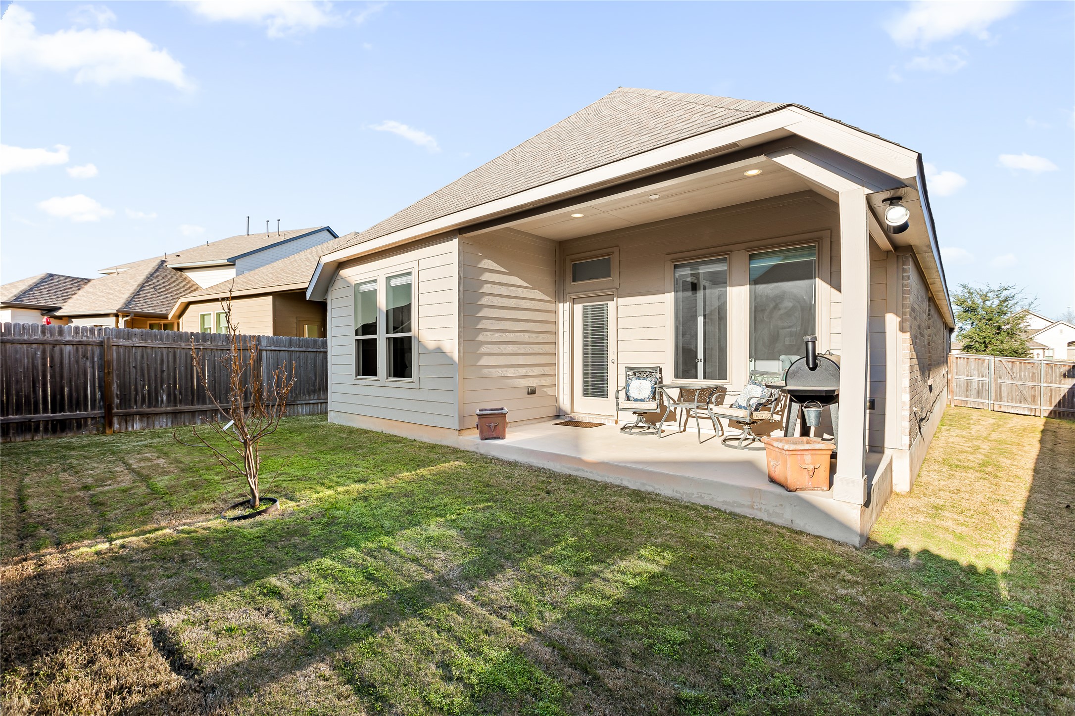 220 Freeman Loop Liberty Hill, TX 78642 - Photo 3 of 40 Backyard is spacious with privacy fencing and a covered back patio.