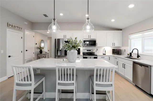 a kitchen with a sink stove and microwave