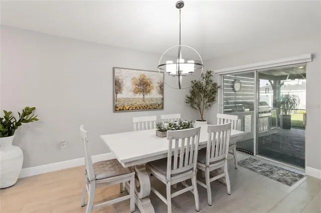 a view of a dining room with furniture wooden floor and chandelier