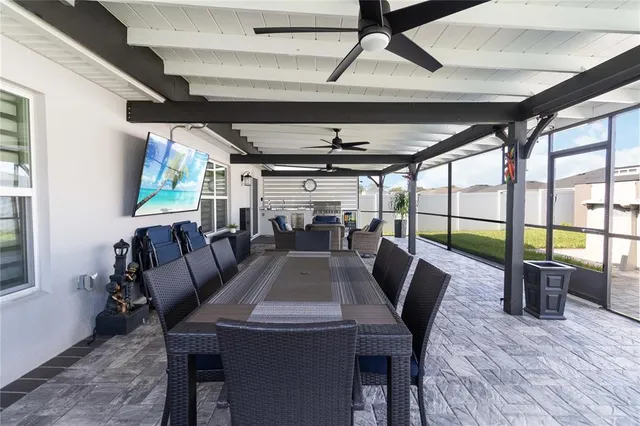 a view of a house with backyard and a tree