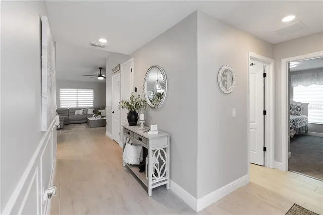 a large white kitchen with a stove a sink a dining table and chairs