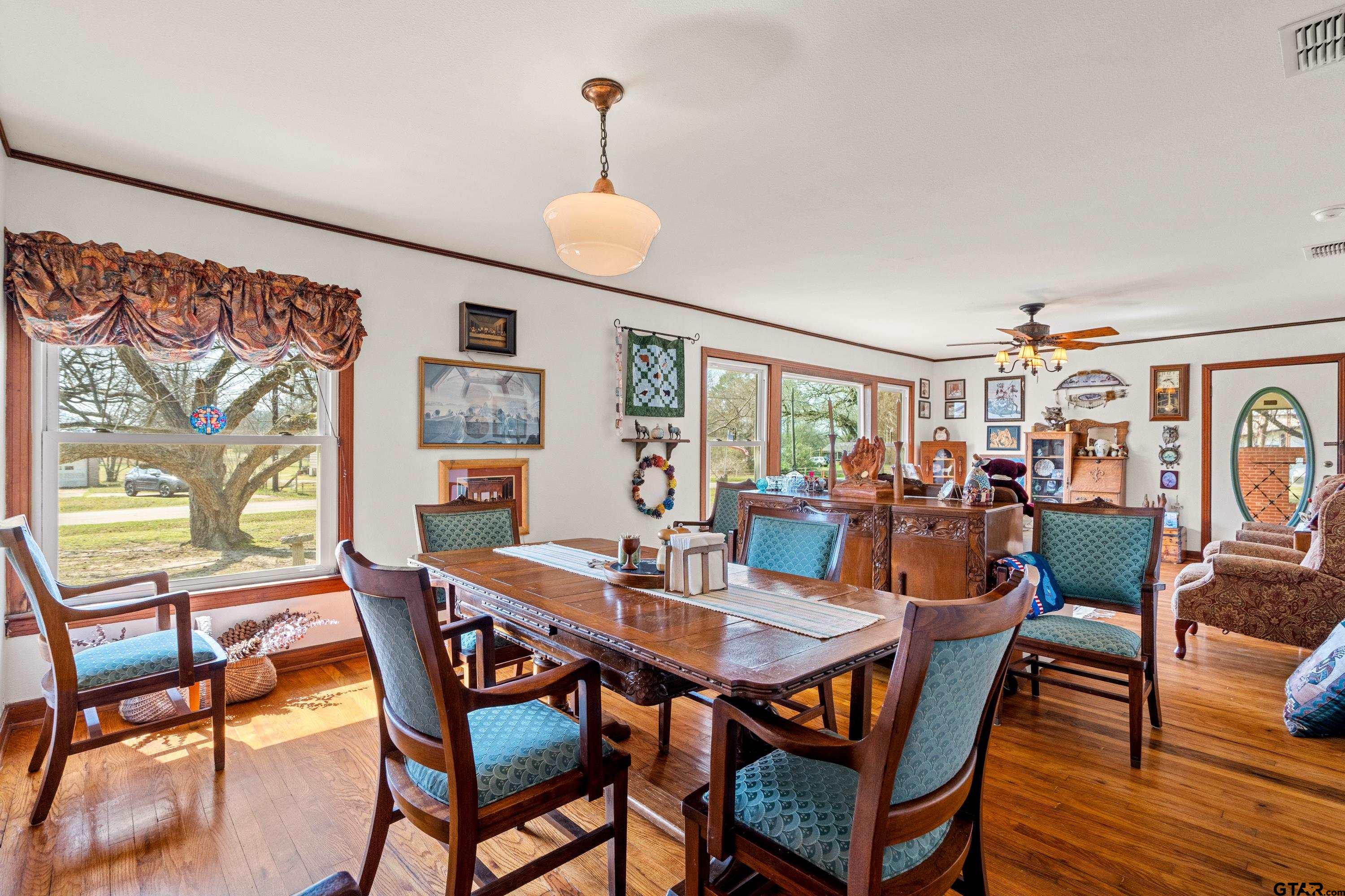 609 East Quitman Street Alba, TX 75410 - Photo 12 of 38 a view of a dining room with furniture and wooden floor