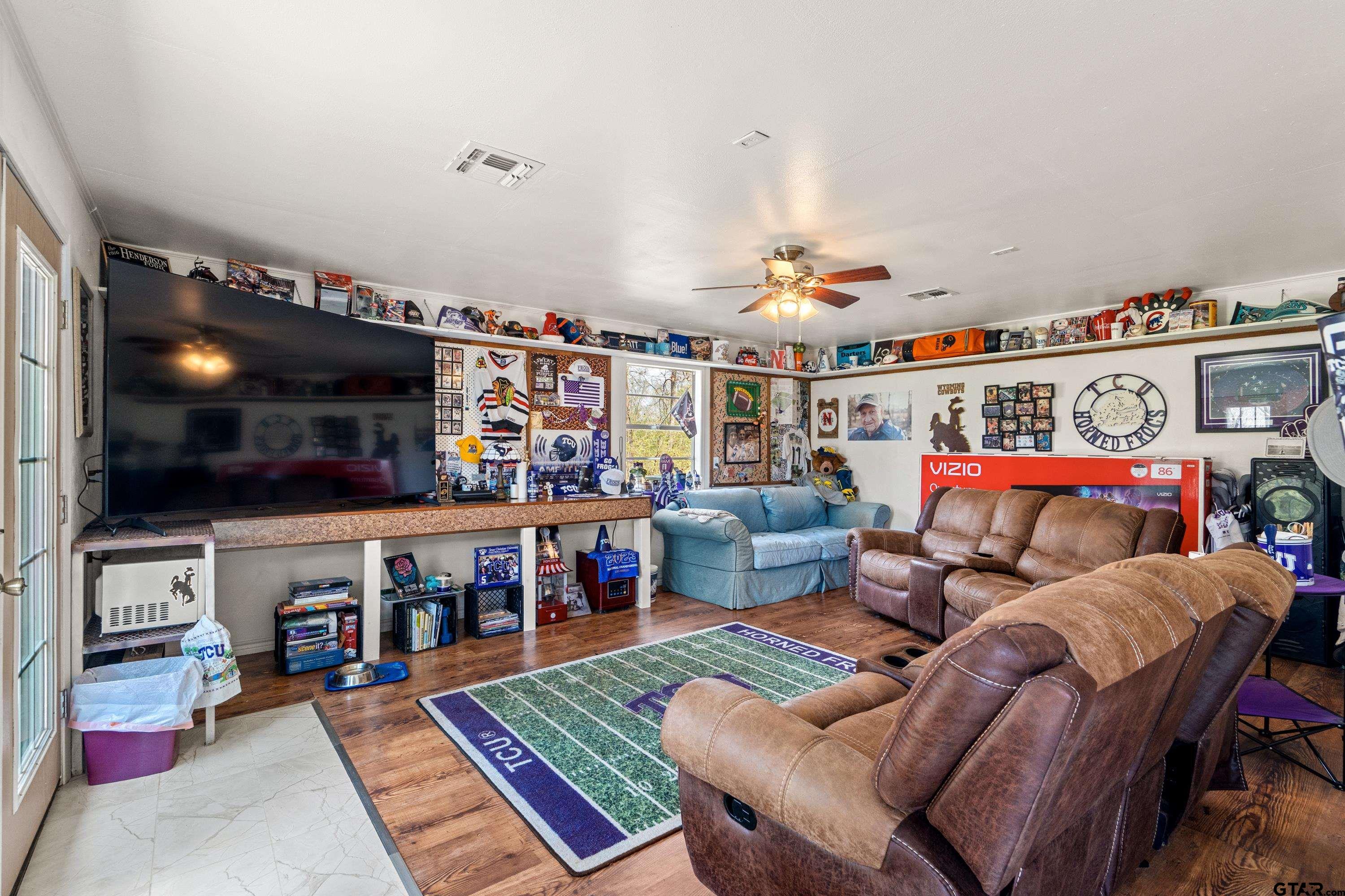 609 East Quitman Street Alba, TX 75410 - Photo 29 of 38 a living room with furniture and a flat screen tv