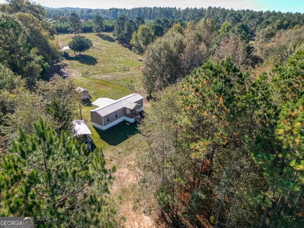 an aerial view of a house with a yard