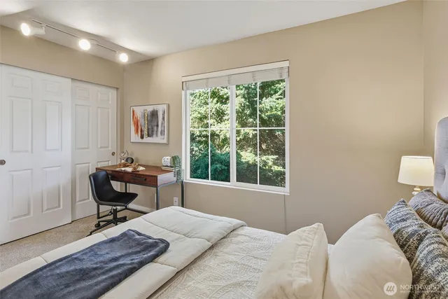 a bedroom with a bed and a window