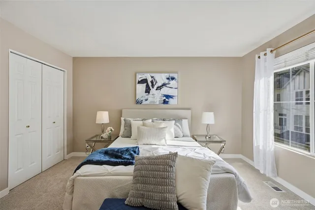 a bedroom with a bed and a window