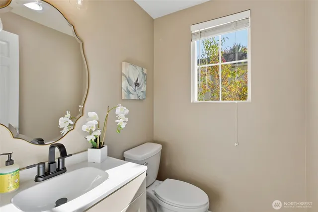 a bathroom with a shower sink vanity mirror and toilet