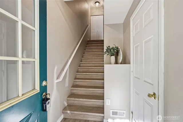 a view of a hallway with wooden floor and entryway