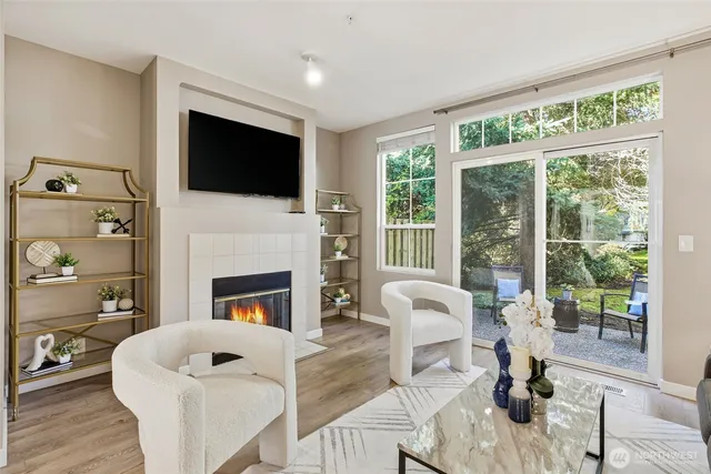 a living room with furniture a fireplace and a flat screen tv
