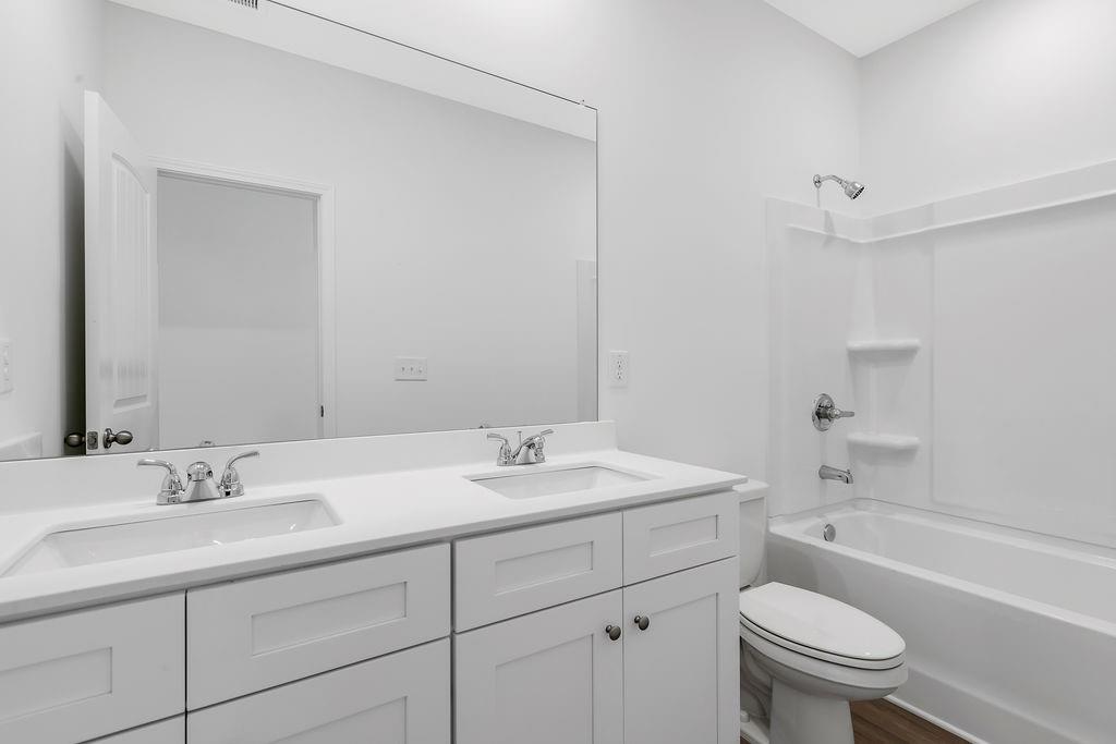172 Sweet Water Lane Southeast Rome, GA 30161 - Photo 21 of 29 a bathroom with a sink a toilet and a bathtub