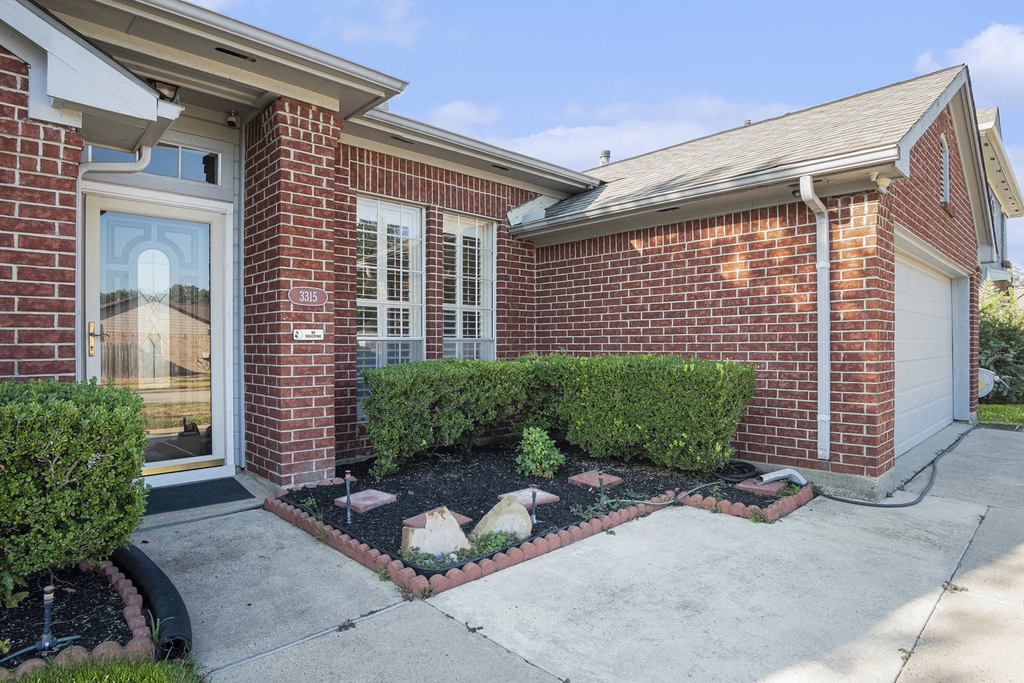 a front view of a house with garden