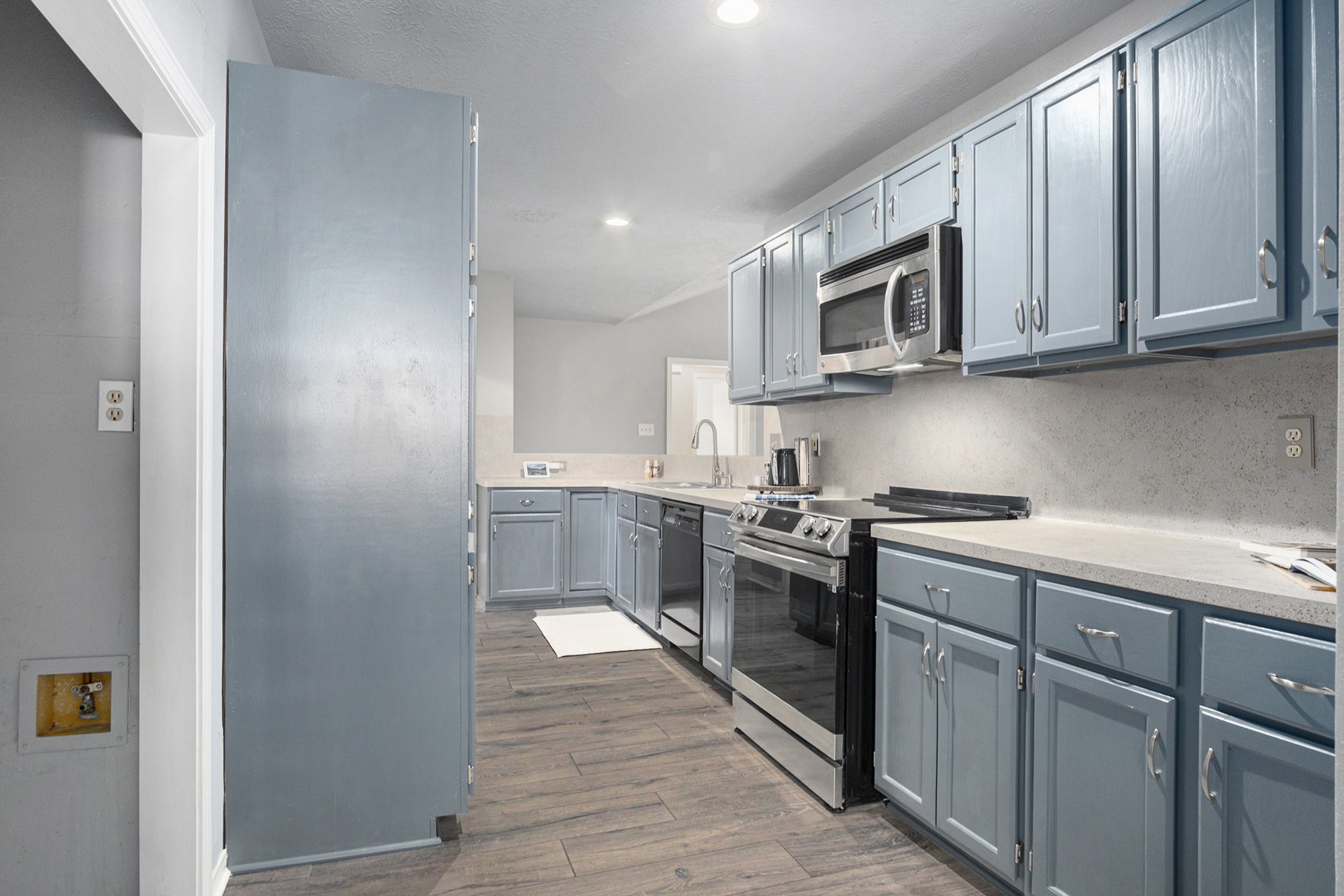 3315 Mourning Dove Drive Spring, TX 77388 - Photo 14 of 44 a kitchen with stainless steel appliances granite countertop a stove a sink and a microwave