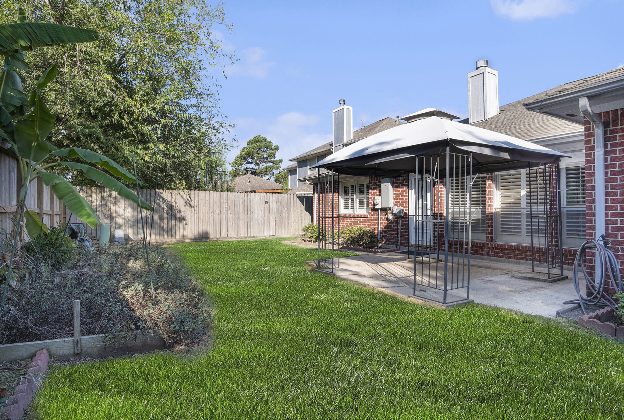 3315 Mourning Dove Drive Spring, TX 77388 - Photo 39 of 44 a view of a patio with a table and chairs under an umbrella