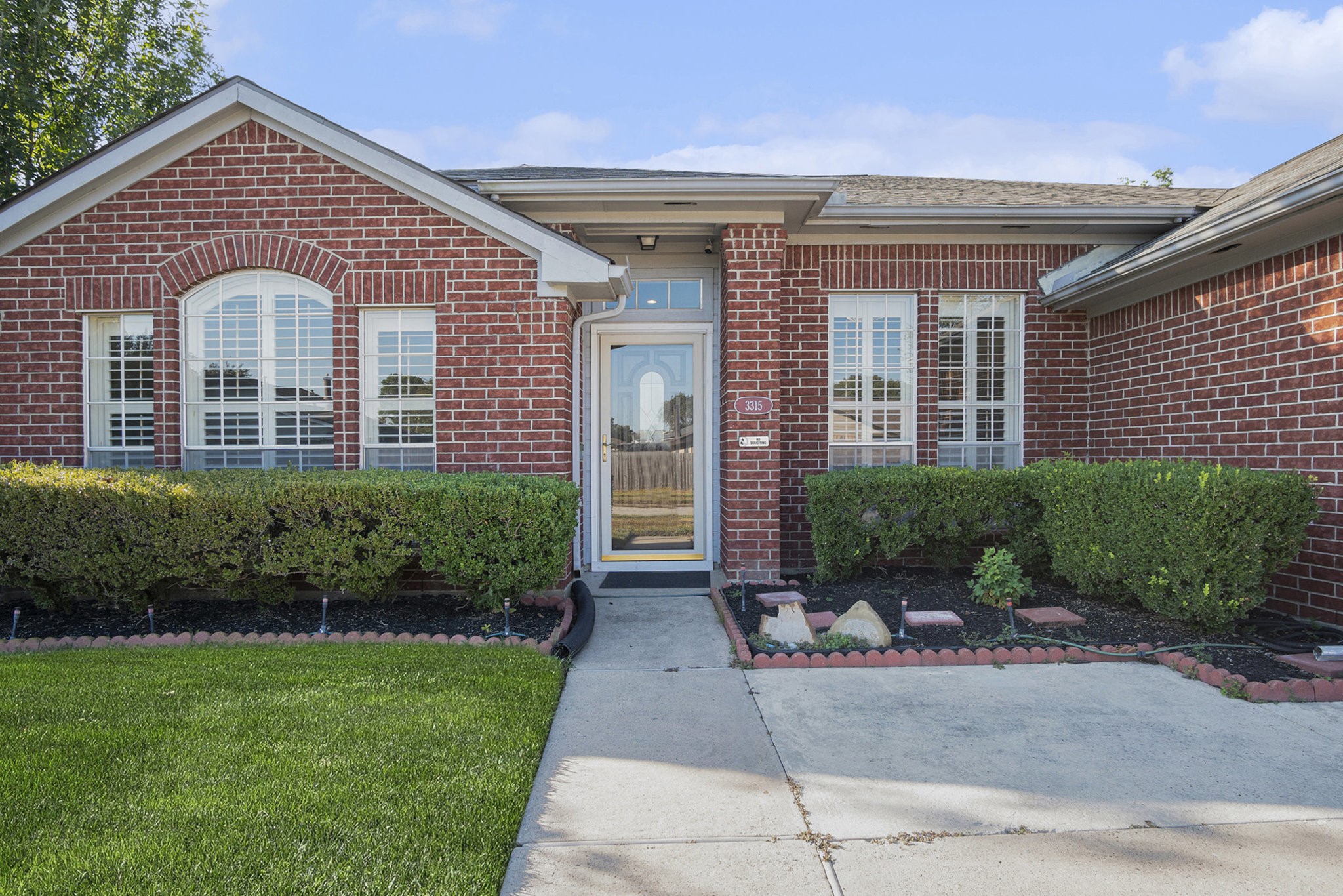 3315 Mourning Dove Drive Spring, TX 77388 - Photo 4 of 44 a front view of a house with a yard and potted plants