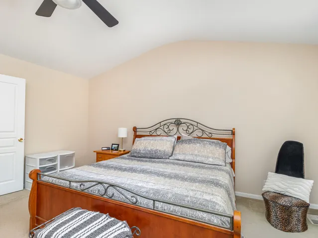 a bedroom with a bed and chair