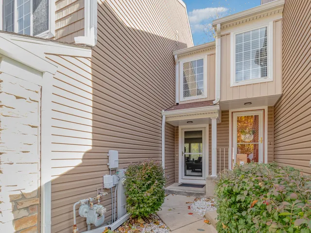 a view of a house with potted plants