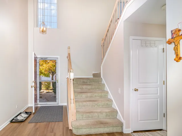 a view of an entryway with wooden floor and door