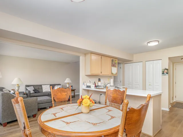 a living room with furniture and a dining table
