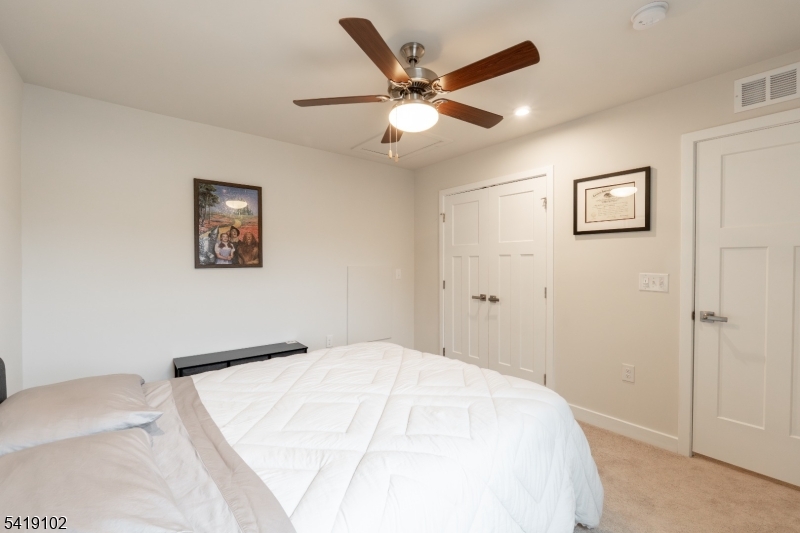 18 Sparrowhawk Street Washington, NJ 07882 - Photo 16 of 31 a bedroom with a large bed and a ceiling fan