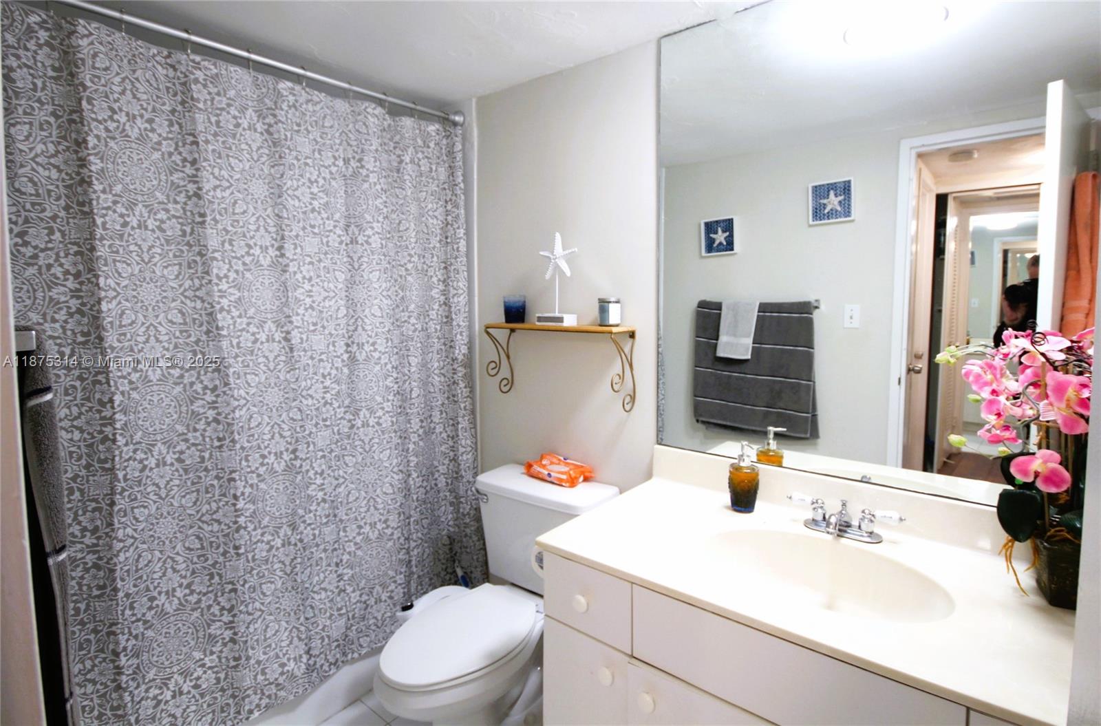 5161 Collins Avenue, Unit 603 Miami Beach, FL 33140 - Photo 12 of 56 a bathroom with a sink toilet and shower