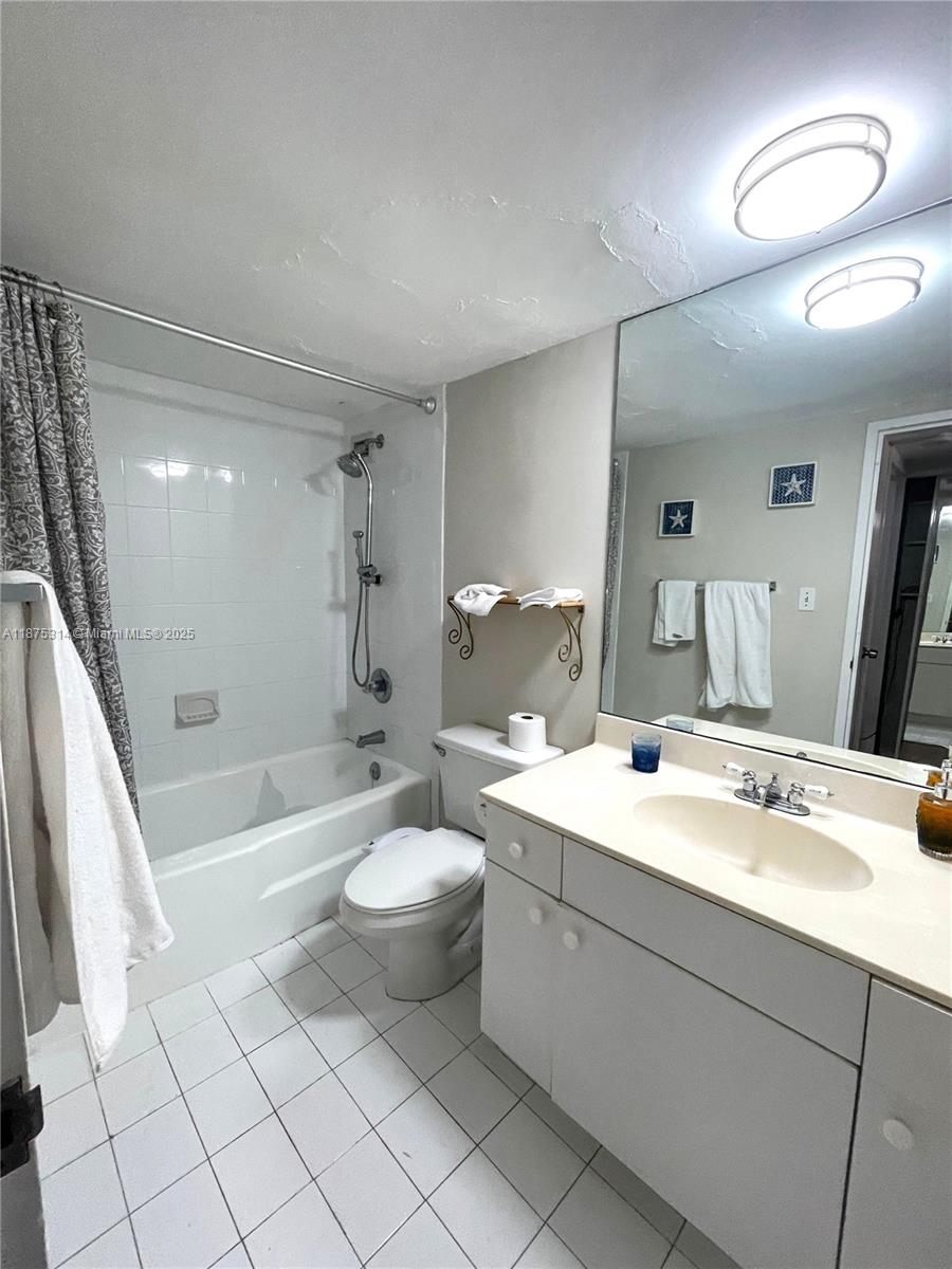 5161 Collins Avenue, Unit 603 Miami Beach, FL 33140 - Photo 14 of 56 a bathroom with a sink a toilet and shower