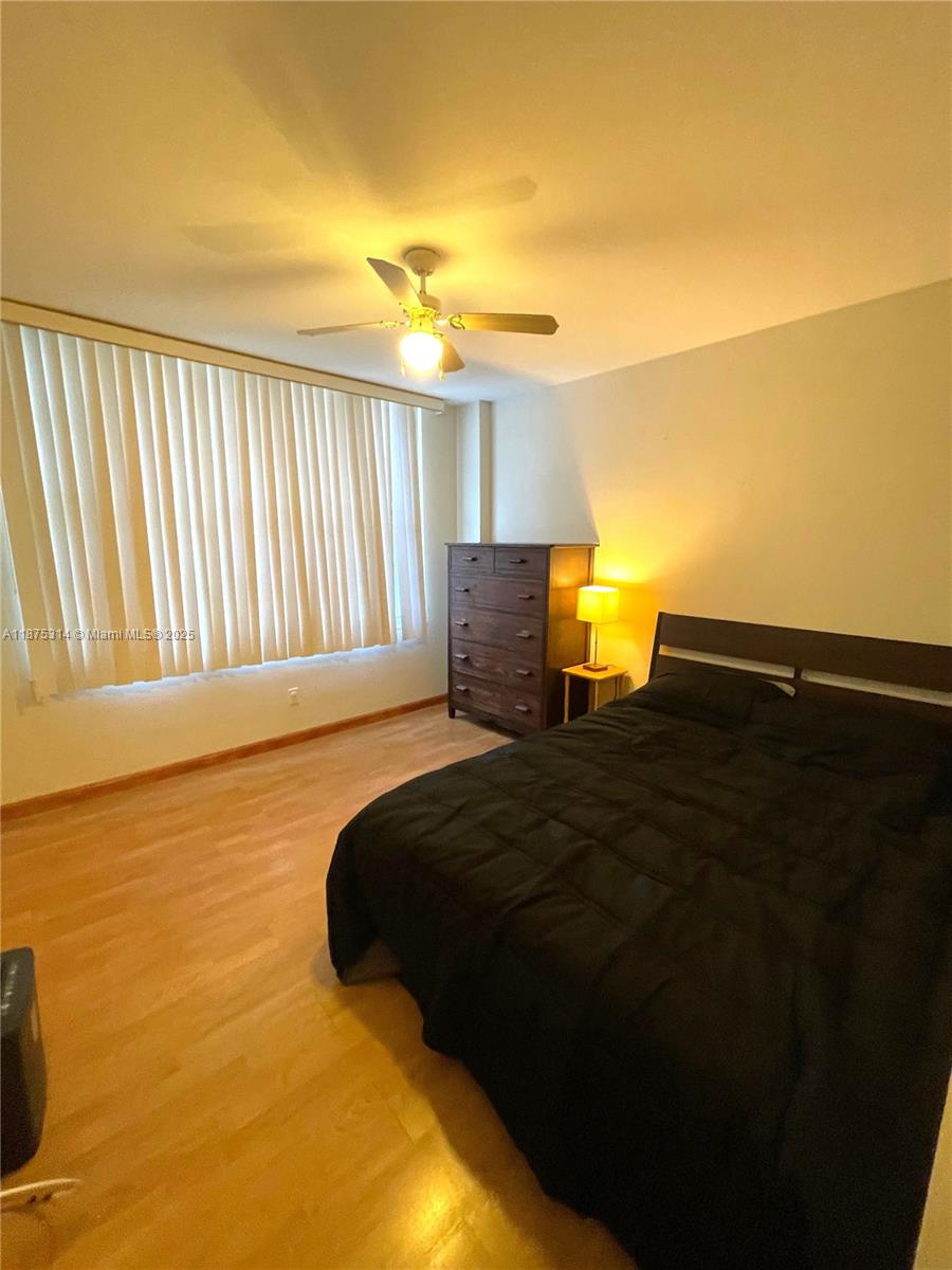 5161 Collins Avenue, Unit 603 Miami Beach, FL 33140 - Photo 15 of 56 a bedroom with a bed and wooden floor