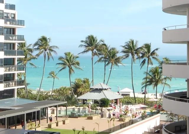 a large building with a palm tree and outdoor space