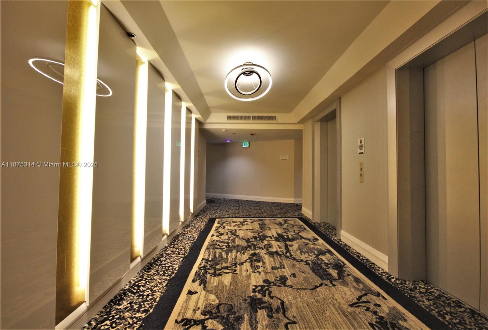5161 Collins Avenue, Unit 603 Miami Beach, FL 33140 - Photo 25 of 56 a view of a hallway with wooden floor