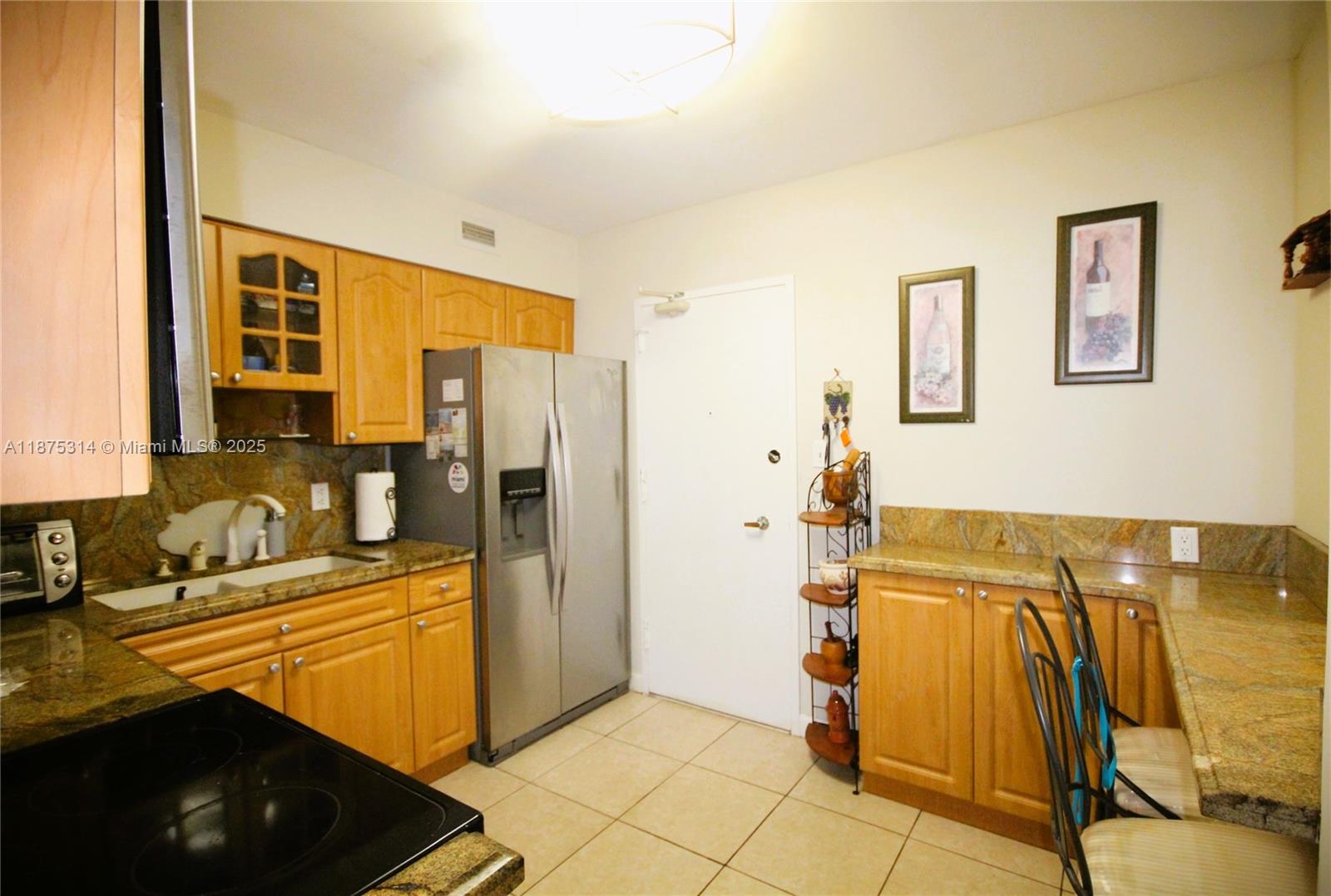 5161 Collins Avenue, Unit 603 Miami Beach, FL 33140 - Photo 26 of 56 a kitchen that has a sink and a stove in it