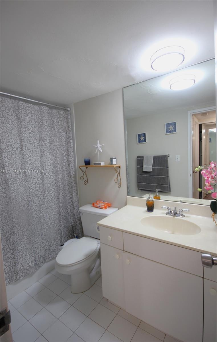 5161 Collins Avenue, Unit 603 Miami Beach, FL 33140 - Photo 27 of 56 a bathroom with a sink a toilet and mirror