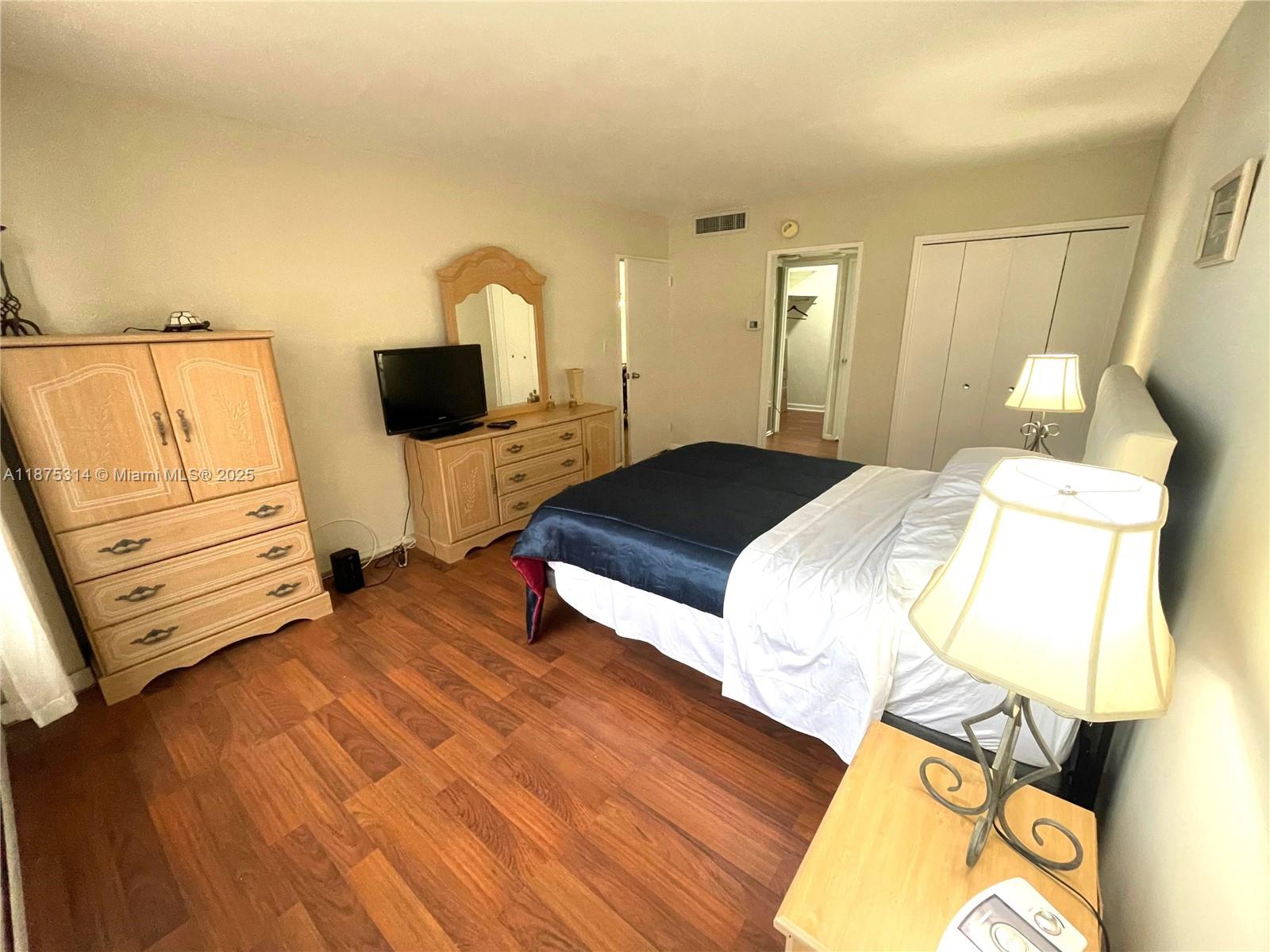 5161 Collins Avenue, Unit 603 Miami Beach, FL 33140 - Photo 10 of 56 a bedroom with a bed and wooden floor