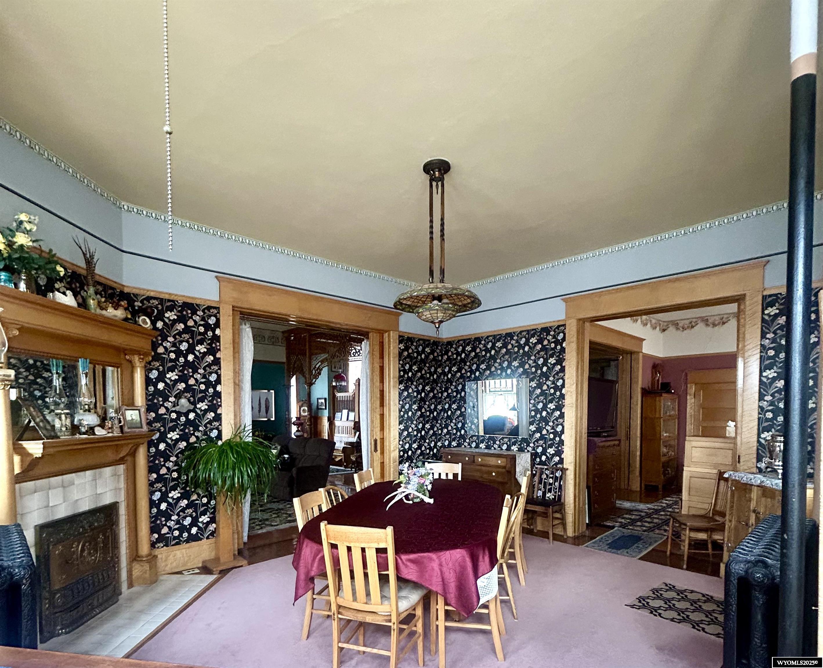 607 West Maple Street Rawlins, WY 82301 - Photo 7 of 47 Tall ceilings, detailed woodwork, fireplace and antique light fixtures