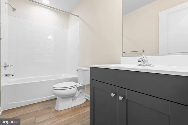 a bathroom with a sink toilet a mirror and shower